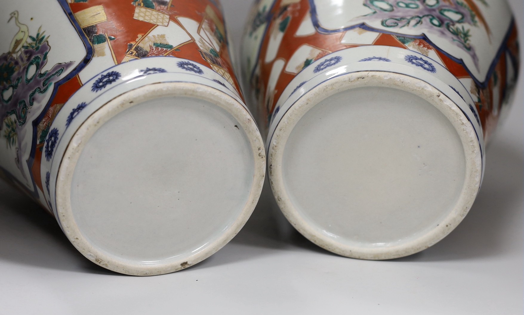 A pair of Imari vases and covers. 39cm high